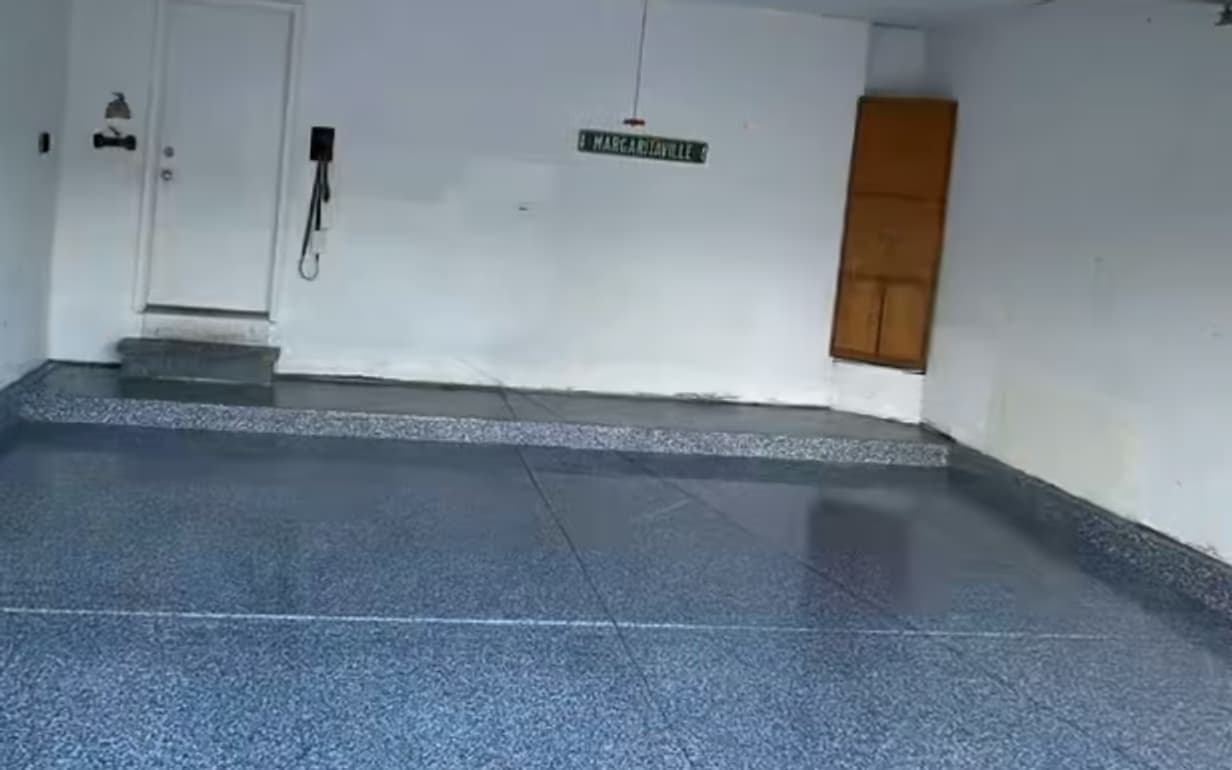 The same garage after Absolute installed a full blue-gray flake epoxy floor